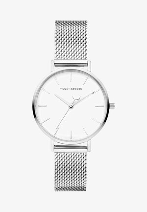 Zilveren gaasarmbandhorloge met een ronde witte wijzerplaat, minimale uurmarkeringen en slanke zilveren wijzers. Merkennaam "Violet Hamden" gedrukt op de wijzerplaat.