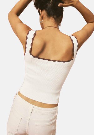 Maiou alb cu dungi, margini maro ondulate și decolteu pătrat, având un design ajustat și material texturat.