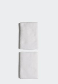Dos servilletas de algodón blancas, texturizadas con un patrón tejido, dobladas ordenadamente sobre un fondo claro. Cada una mide aproximadamente 20 x 30 cm.