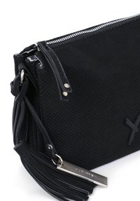 Black perforated leather bag with a zip closure, featuring a leather tassel and metal tag, designed with a smooth texture and minimal hardware.