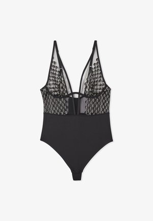 Schwarzer Body mit tiefem V-Ausschnitt, ausgestattet mit einem Netzpaneel, das mit kreisförmigen Mustern verziert ist. Riemchen-Design auf der Rückseite, glattes Material, ohne Verzierungen.