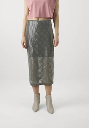 Silver sequin midi skirt with a ribbed texture and subtle sheen, paired with beige ankle boots. The top is a cropped pink shirt.