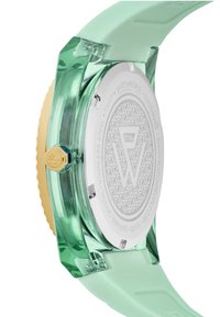 Orologio in silicone verde traslucido con corona dorata. Il retro in acciaio inossidabile presenta un motivo geometrico. Cinturino morbido di colore menta.