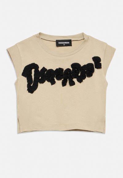 Beige cropped sleeveless toddler shirt with black textured "Dsquared2" logo across chest and black brand tag inside collar.