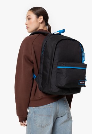 Black fabric backpack with blue accents, featuring a front pocket and adjustable straps. Smooth texture and rectangular shape.