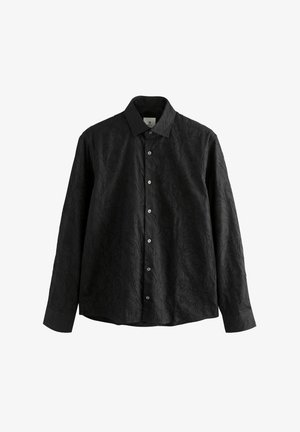 Camicia a maniche lunghe nera con motivo a foglia in rilievo, davanti con bottoni e colletto classico. Realizzata in tessuto leggero, finitura liscia.