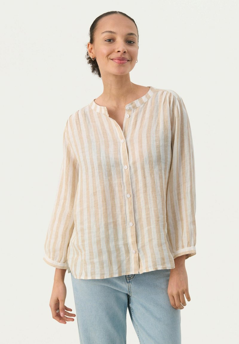 Lightweight, striped linen blouse in beige and off-white. Features a band collar, long sleeves, and button front. Relaxed fit with rolled cuffs.