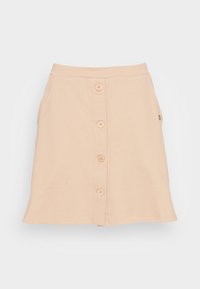 Saia de algodão bege com forma evasê, apresentando um fecho frontal com botões, cinco botões e um discreto bolso lateral.