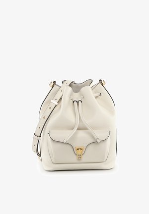 Sac seau en cuir crème avec poche avant, fermoir doré et bandoulière réglable.