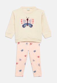 Cream sweatshirt with pink and blue butterfly applique, paired with light pink leggings featuring a butterfly print in various colors.
