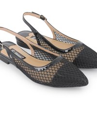 Zapatos negros tipo slingback con un diseño de malla, punta afilada y acentos de charol brillante. Tacón plano con una plantilla beige.