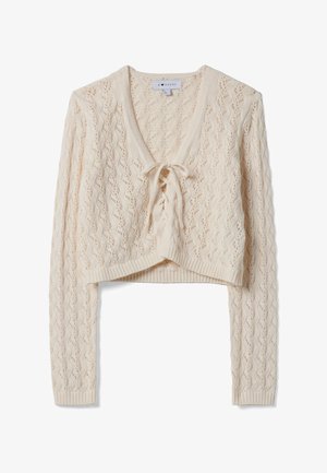 Roomkleurig gebreid cropped vest met lange mouwen en een striksluiting bij de V-hals, voorzien van een kanten patroon en geribde randen.