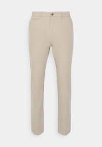 Beige chinos ar taisnu kāju dizainu, pogu aizdari un divām priekšējām kabatām. Izgatavoti no mīksta, izturīga auduma ar gludu tekstūru.