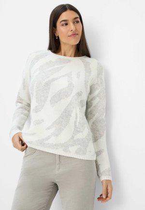 White knit sweater with light gray abstract patterns, round neck, long sleeves, and ribbed cuffs. Soft texture, relaxed fit, and side slit.