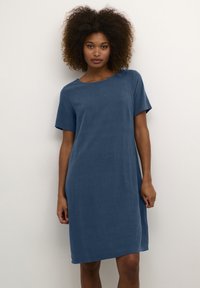 Short-sleeve blue dress with a relaxed fit, round neckline, and side pockets. Made of soft fabric with a smooth texture.