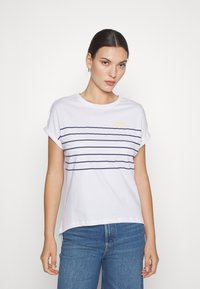 White short-sleeve t-shirt featuring horizontal navy stripes and a yellow sun graphic on the left chest. Fabric is soft cotton with a relaxed fit.