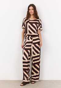 Striped blouse and wide-leg pants set in cream, black, and rust colors. Features a relaxed fit, smooth fabric, and elastic waistband.