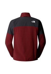 Veste polaire pour homme avec un corps bordeaux, des épaules et un haut du dos noirs, et un logo The North Face blanc sur le haut du dos à droite.