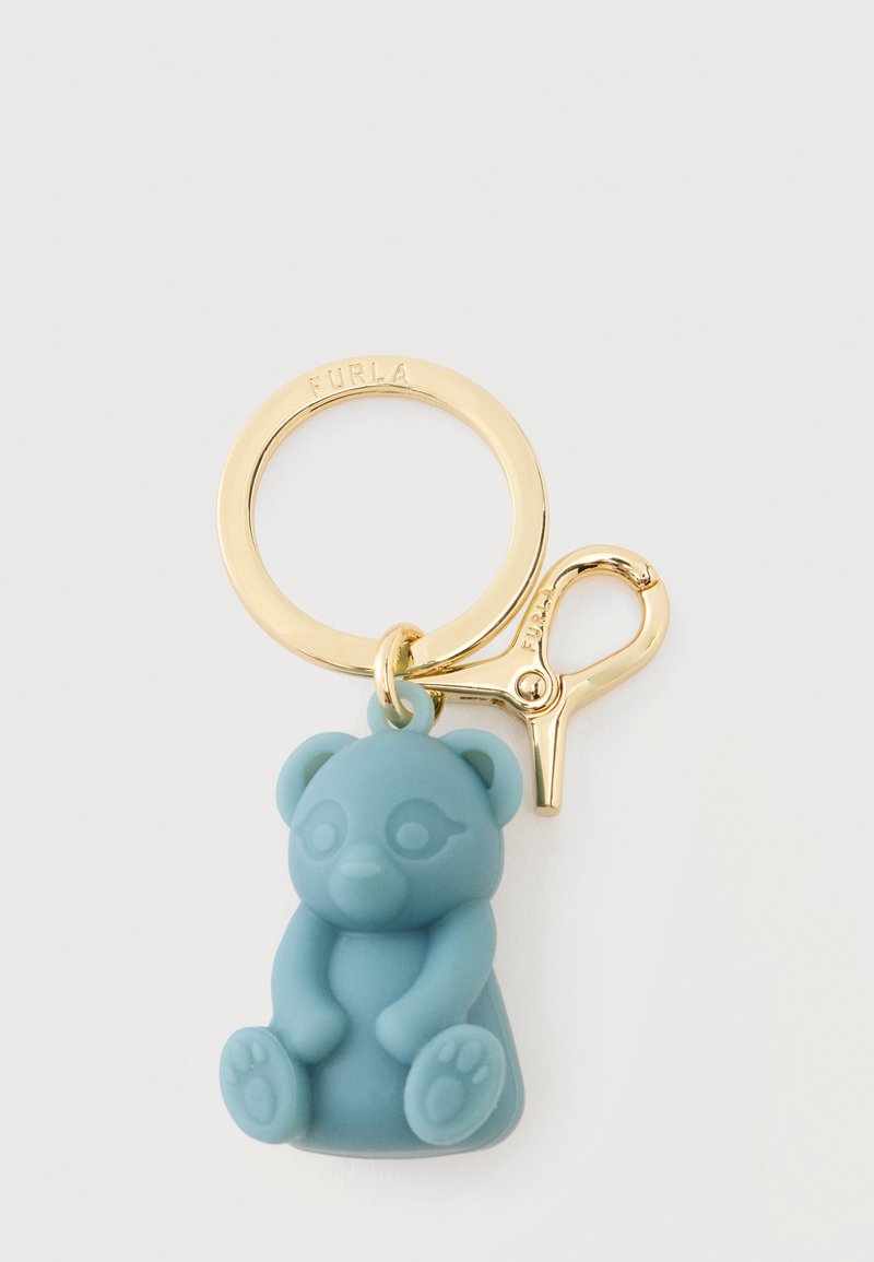 Porte-clés doré avec mousqueton et breloque ours en silicone bleu attaché, avec des détails embossés sur l'ours et l'anneau.