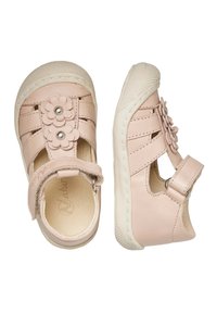 Pink leather sandals with flower accents, open toe design, and adjustable strap. Features textured rubber sole and cutout sides.
