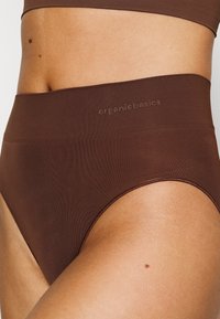 Brown high-waisted underwear made from soft material. Features a smooth texture and subtle branding on the waistband.
