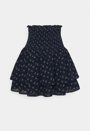 Granatowa spódnica warstwowa z małym różowym kwiatowym wzorem oraz marszczonym, falbanianym wysokim stanem.