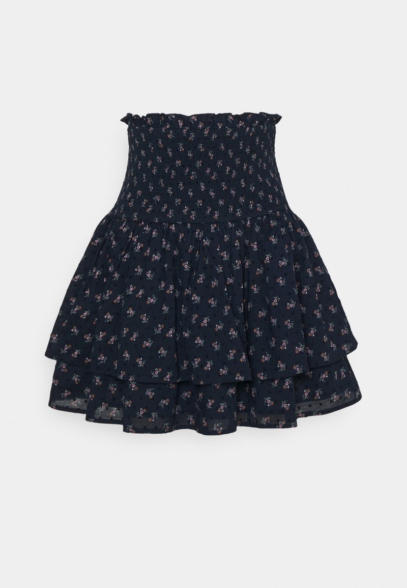 Jupe bleu marine à volants avec petit motif floral rose et taille haute smockée et volantée.