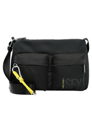 Black textured crossbody bag with two front zip pockets, adjustable strap, and yellow strap detail with metal carabiner clip.