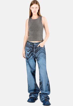 Gray ribbed tank top, high-waisted blue denim jeans with a wavy pattern, loose fit, and wide legs, paired with blue slip-on shoes.