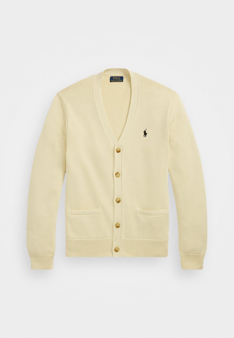 Beige stickad cardigan med V-ringning, fem gyllene knappar, två frampocket och en liten svart logotyp på vänster bröst.