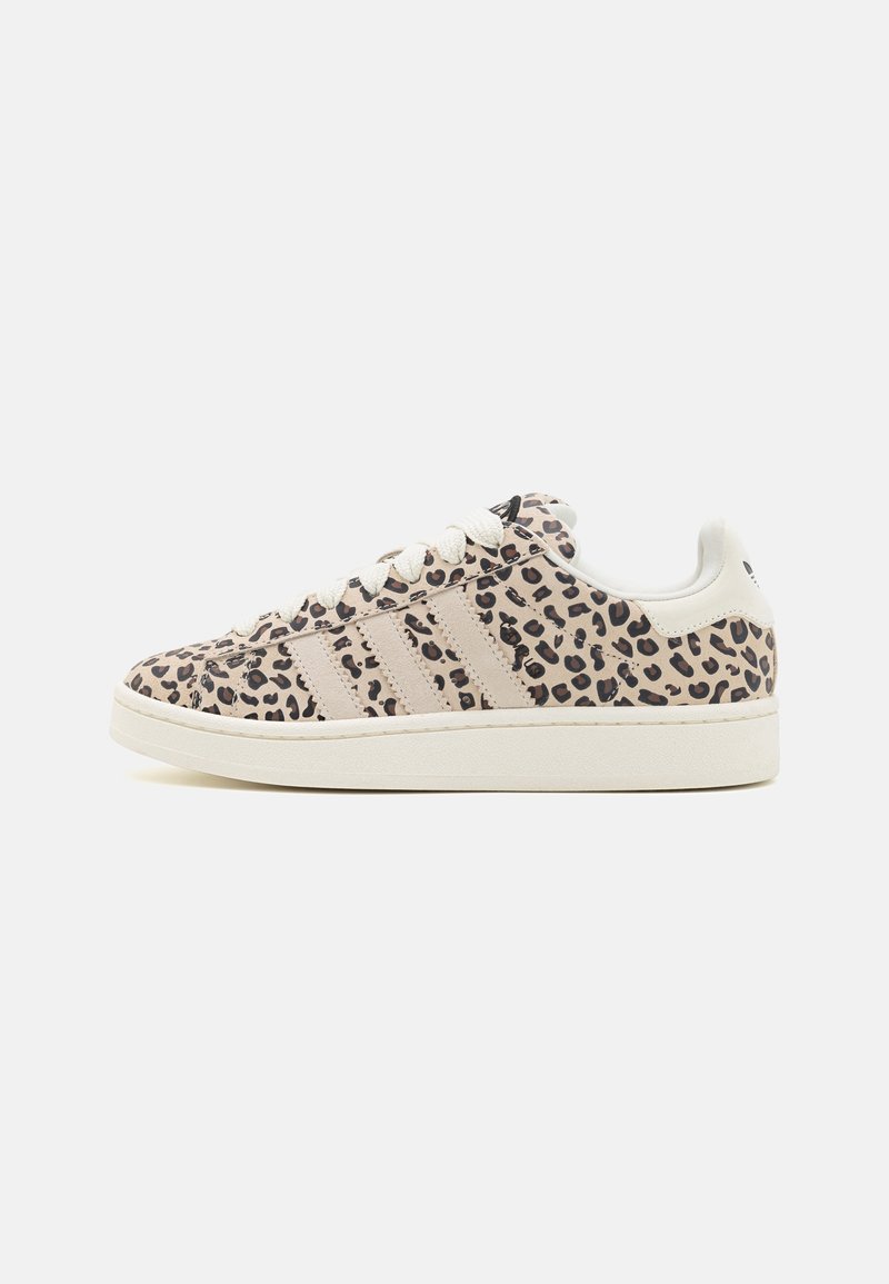 Low-top sneaker with beige and black leopard print, cream-colored laces, three beige side stripes, and a white sole on a white background.