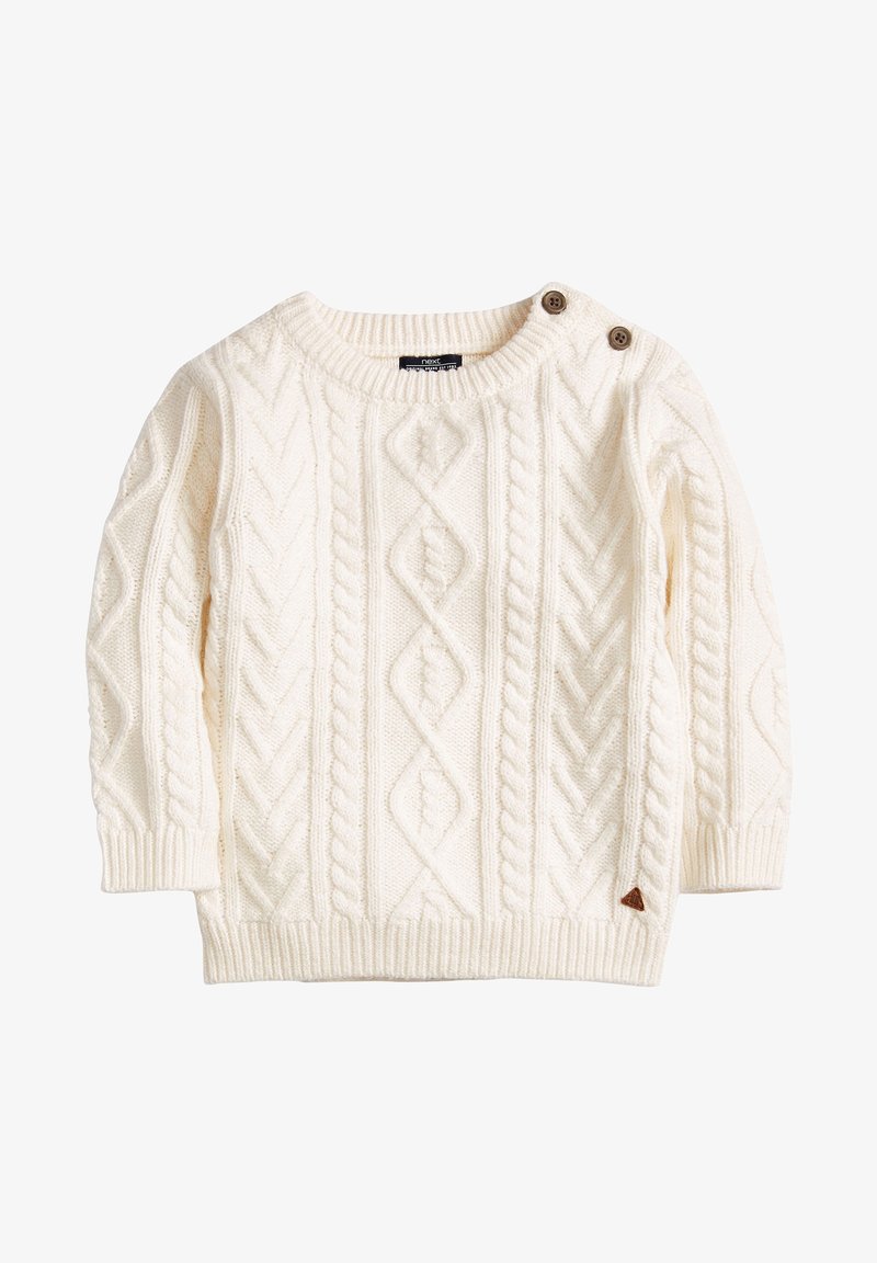 Pull en maille torsadée couleur crème avec manches longues et deux boutons marron sur l'épaule gauche, poignets et ourlet côtelés.