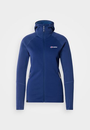 Ζακέτα fleece σε μπλε ναυτικό χρώμα με φερμουάρ, ψηλό γιακά, δύο πλαϊνές τσέπες και εφαρμοστή γραμμή. Διαθέτει αντίθετες ραφές και λογότυπο στο στήθος.