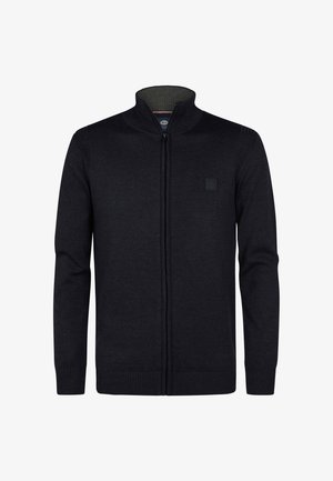 Dark knit cardigan with a high collar, full front zipper, ribbed cuffs and hem, featuring a small, textured logo patch on the chest.