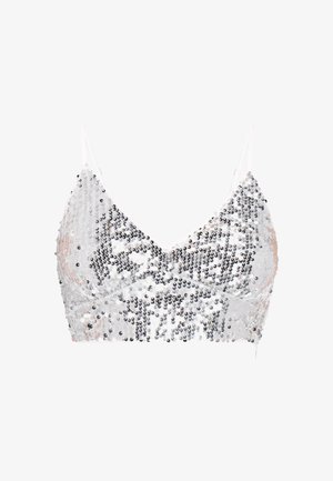 Bralette argentée pailletée avec fines bretelles blanches, présentant un décolleté en V et une surface texturée créée par des paillettes alternées.
