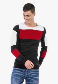 Gestrickter Pullover mit horizontalen Streifen in Rot, Weiß und Schwarz; texturierte Ärmel; runder Halsausschnitt; Logodetail am Saum.