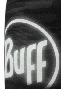Buff neckwear in black and white, featuring a prominent circular logo. The fabric is textured with a smooth finish.