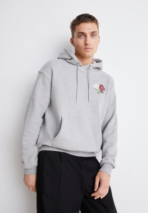 Gray hooded sweatshirt with front pocket; features red and white embroidered rose design on the left chest. Smooth fabric and relaxed fit.