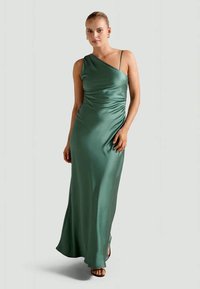 Satin green dress with one shoulder strap, featuring a ruched design and a floor-length fit. Smooth texture and elegant silhouette.