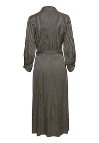 Svart och vit prickig klänning med krage, långa ärmar och midjeband. Materialet verkar lätt och har en mjuk textur.