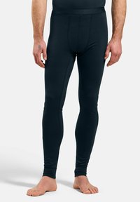 Black, fitted leggings made of stretchy fabric, featuring a smooth texture, long leg design, and a comfortable waistband.
