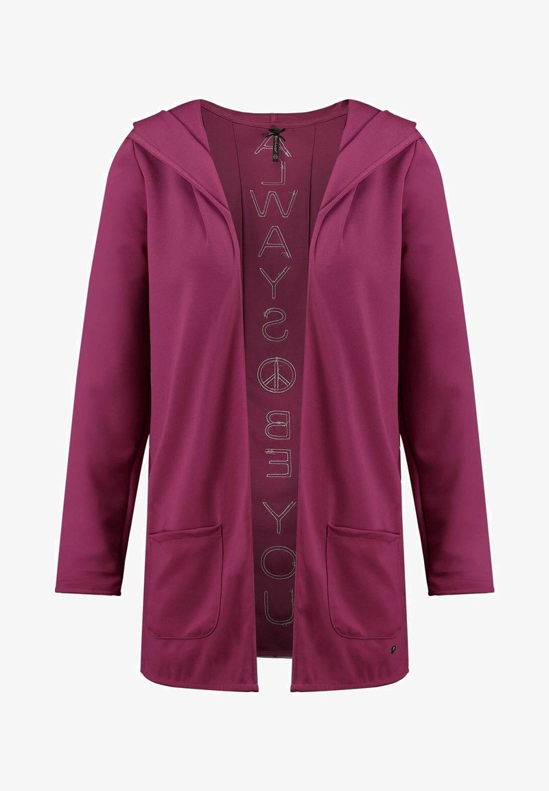 Veste violette à manches longues, ouverte à l'avant, avec deux poches avant, une capuche, et un symbole de paix vertical avec du texte à l'intérieur.