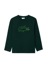 Camicia in cotone verde scuro a maniche lunghe con un design a contorno di coccodrillo in cucitura gialla. Collo a giro e vestibilità regolare.