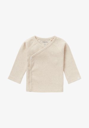 Long-sleeve wrap top in light beige ribbed fabric with snap closures at the side and sleeve hem. Features a small logo emblem on front.