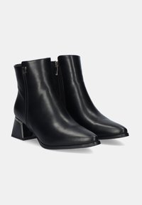Botas de cuero negro hasta el tobillo con punta afilada, cremallera lateral y un tacón grueso con detalles metálicos. Textura suave con un mínimo de adornos.