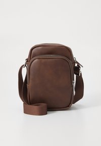Brown leather crossbody bag with smooth texture, zip closure, and adjustable fabric strap; rectangular shape with rounded edges.