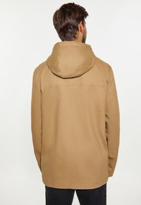 Beige gewatteerde jas met een gladde textuur, met een eenvoudige silhouet en zichtbare stikdetails op de achterkant. Geschikt voor casual kleding.