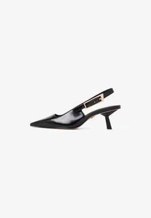 Black patent leather slingback shoes with a pointed toe, featuring a gold-tone buckle accent and a short, block heel.