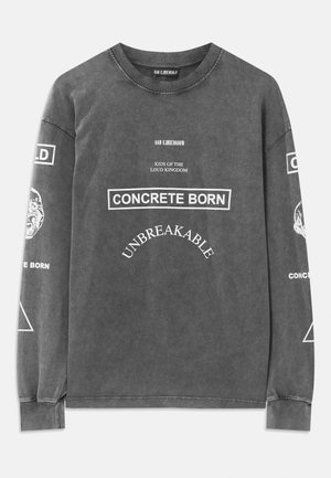 Dark gray long-sleeve shirt with white text "HAN KJØBENHAVN," "KIDS OF THE LOUD KINGDOM," "CONCRETE BORN," and "UNBREAKABLE" on front.