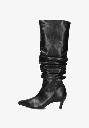 Black leather knee-high boot with a slouchy design, pointed toe, and a low heel. Smooth texture and subtle sheen throughout.
